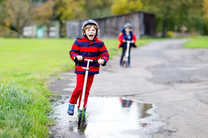A child riding a scooter outdoors